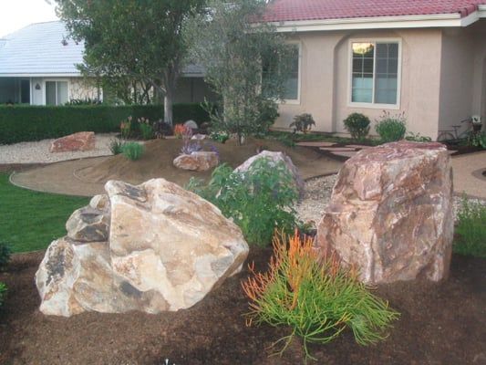 a rock garden in front of a house