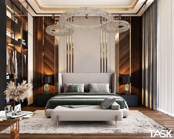 a bedroom with a large bed and chandelier hanging from the ceiling