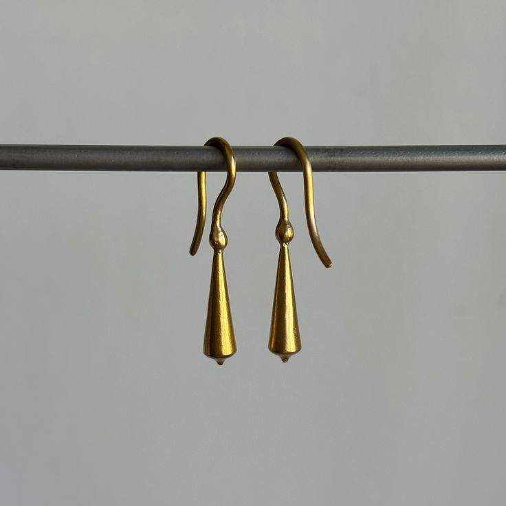 Stately everyday earrings that unite form with fluidity. 22k yellow gold Tapered pod is 5mm x 18mm (3/16" x 3/4")Earrings hang 1 3/16" from the earEach earring weighs 2.4g Classic 22k Gold Earrings, Everyday Hand Forged Teardrop Earrings, Hand Forged Teardrop Brass Earrings, Hand Forged Brass Teardrop Earrings, French Hook Drop Earrings For Everyday, Everyday Drop Earrings With French Hook, Classic Dangle Brass Earrings, Classic Brass Drop Earrings, Classic Brass Dangle Earrings