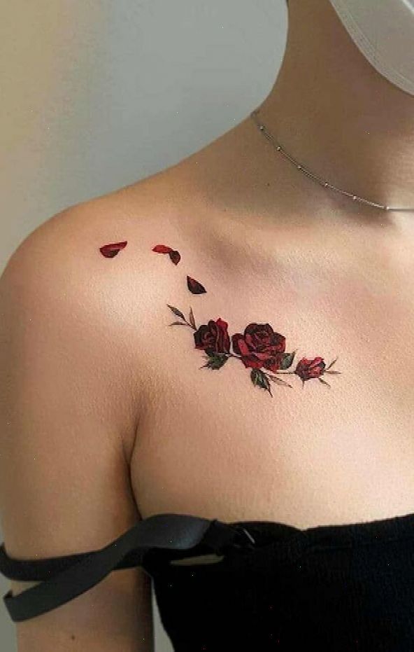 a woman's shoulder with red roses on it