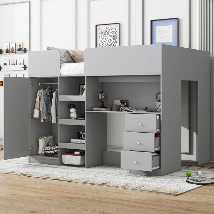 a gray loft bed with drawers underneath it and a white rug on the floor next to it