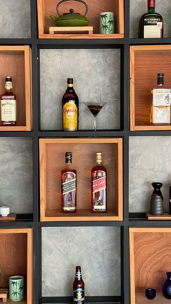 several wooden shelves filled with different types of bottles and glasses on top of each shelf