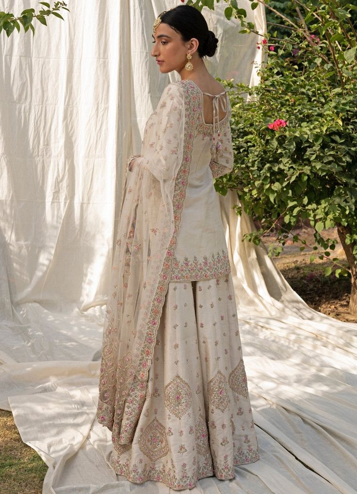 Featuring an ivory raw silk sharara set embroidered with traditional zardozi using Resham, Cutdana, Dabka and Sequins. Teamed with a beautifully embroidered dupatta. Composition: Kurta and Sharara- Raw Silk, Dupatta- Net Care: Dry Clean Only and Vacuum Storage This product can be customised for colour, sleeves, length of blouse and neck design Delivery : 8-10 weeks as the product is hand crafted. For more information and sizes please contact fabiliciousfashion@gmail.com or visit our Copenhagen studio.About the Designer : Angad Singh's journey in the world of fashion started with at an early age as he grew up in a family business that was immersed in couture. Seeking to expand his knowledge, Angad made the decision to study at Parsons School of Design in New York where he honed his skills a Raw Silk Sharara, Silk Sharara, Sharara Designs, Desi Dress, Kurta Sharara Set, Kurta Sharara, Pakistani Fancy Dresses, Desi Clothes, Indian Wedding Wear