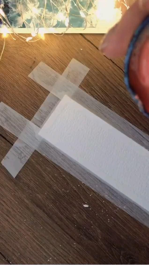 someone is making a cross out of paper