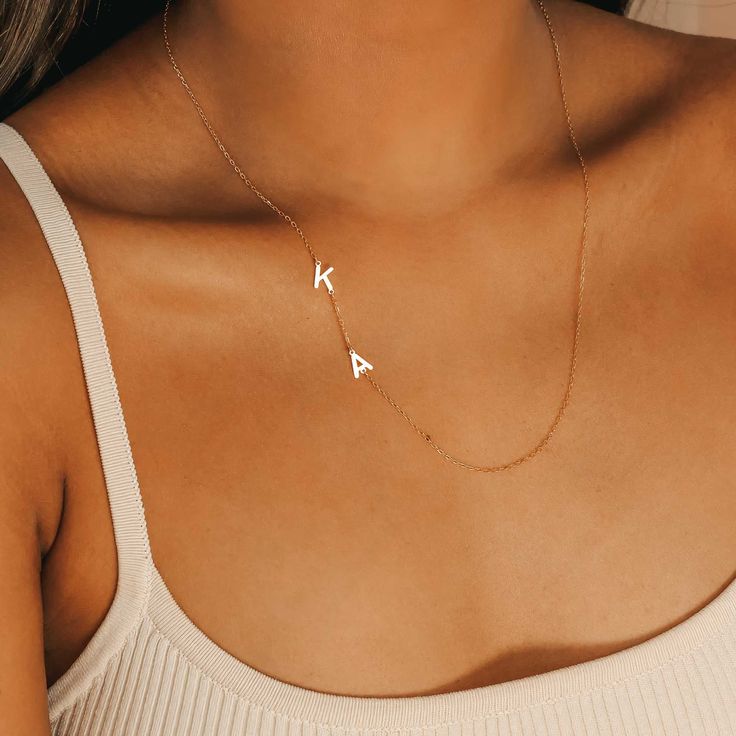 CUTE SIDEWAYS INITIAL LETTER NECKLACE Introducing our new Cute Sideways Initial Necklace! This dainty, elegant necklace showcases the initials or word of your choice perfectly designed to hang asymmetrically. A unique way to introduce yourself while keeping personal details to yourself. CHARACTER LIMIT Max 7 letters per necklace ITEM SPECIFICATIONS • Finish: 925 Sterling Silver ∙ 18K Gold ∙ Rose Gold• Dimensions: Length 15” Trendy Initial Pendant Necklace With Clavicle Chain, Simple Name Necklace With Delicate Chain, Simple Initial Pendant Necklace With Clavicle Chain, Trendy Initial Pendant Necklaces With Initials, Simple Initial Necklace With Clavicle Chain, Trendy Initial Pendant Necklace With Delicate Chain, Minimalist Monogram Name Necklace With Initial Pendant, Minimalist Monogram Initial Pendant Name Necklace, Personalized Minimalist Initial Necklace