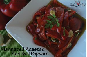 a square white plate topped with red peppers and sliced onions on top of a green table cloth