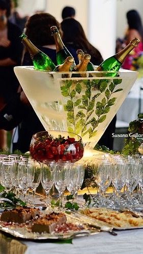 a table topped with lots of glasses filled with wine and food next to each other