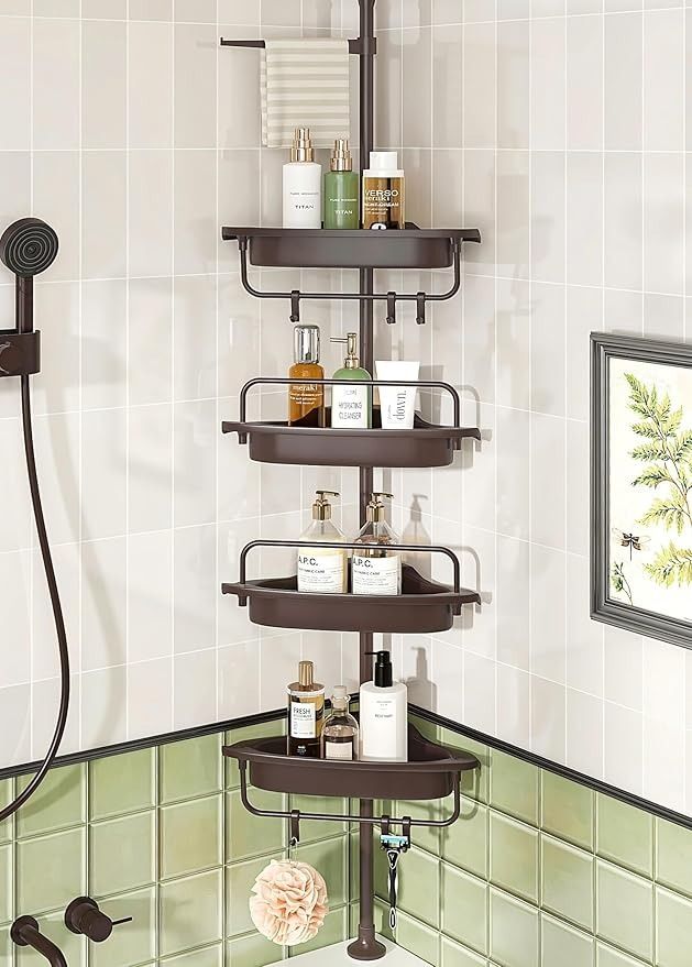 a corner shower shelf in a bathroom with green tile