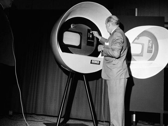 a man standing in front of a big tv