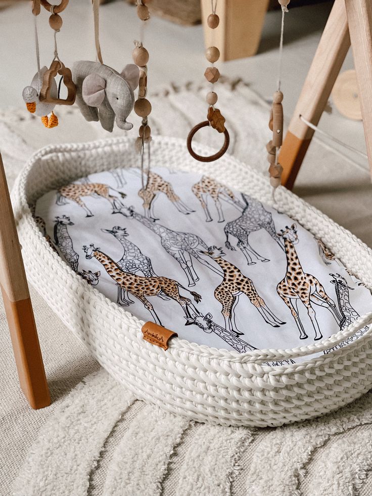 a baby crib with giraffes on it