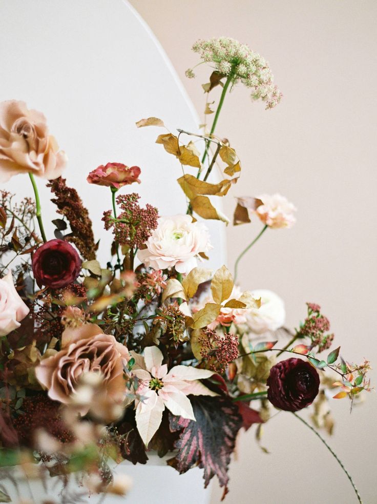 a vase filled with lots of different types of flowers