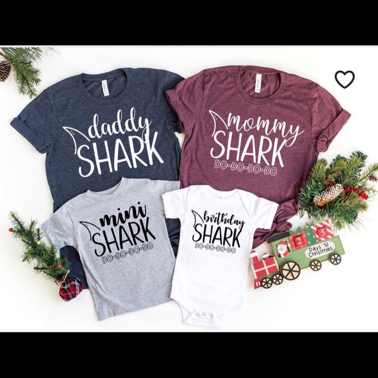 three shirts with the words mommy shark, daddy shark and mommy shark on them next to christmas decorations