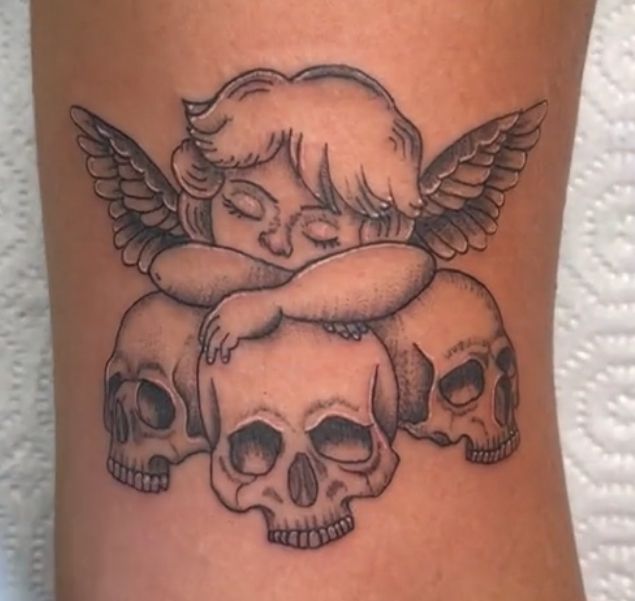 a tattoo with skulls and an angel on it