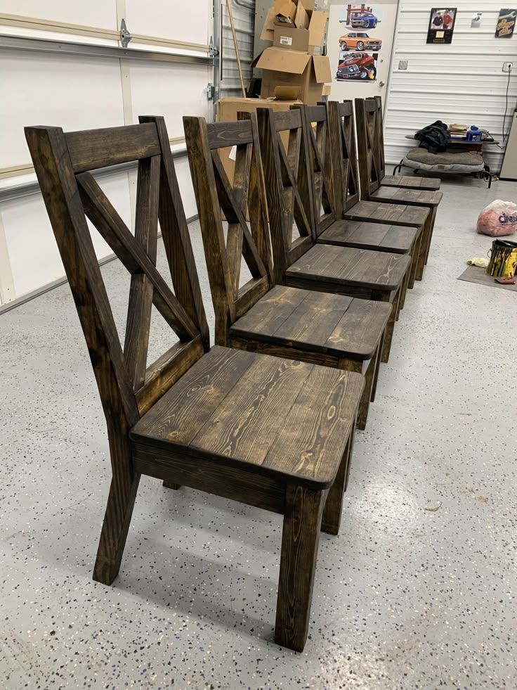 several wooden benches lined up in a garage