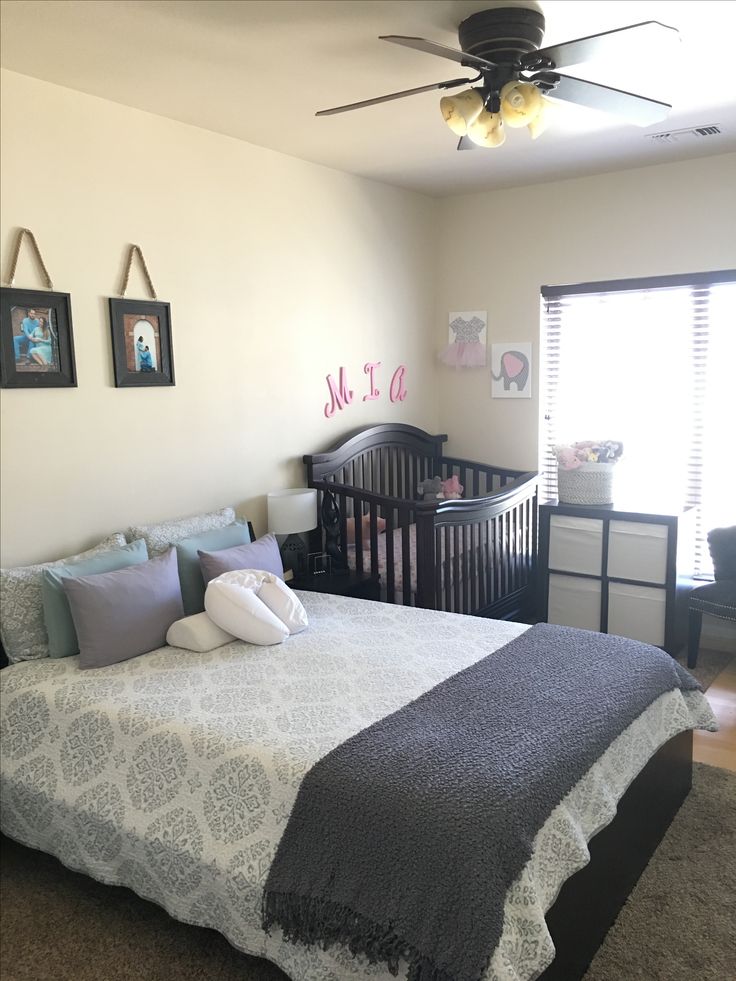 a baby's room with a crib, dresser and bed