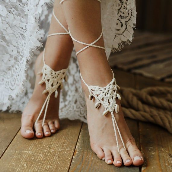 Whether you wear them with your shoes or as true barefoot sandals, these elegantly crocheted anklets have a down-to-earth yet romantically elegant air.  They’re crafted with a lovely, macramé-inspired lace design so they add a touch of sensory texture to your style.These lace barefoot sandals go effortlessly from everyday wear to weddings and festivals – and every dance class or beach party in between.  Since they loop over the toe and tie behind the ankle, it’s easy to make them fit just right Macrame Footwear, Macrame Shoes, Crochet Anklet, Macrame Sandals, Hobbit Wedding, Comfy Crochet, Crochet Bra Pattern, Lace Barefoot Sandals, Barefoot Sandals Wedding