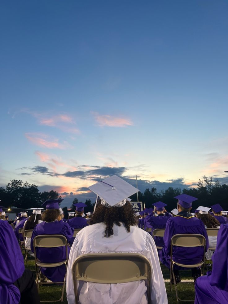 a group of people sitting in chairs at a graduation ceremony