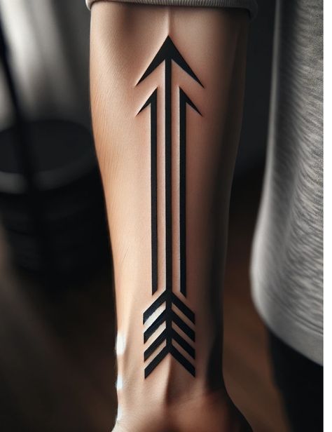 a woman's leg with an arrow tattoo on it