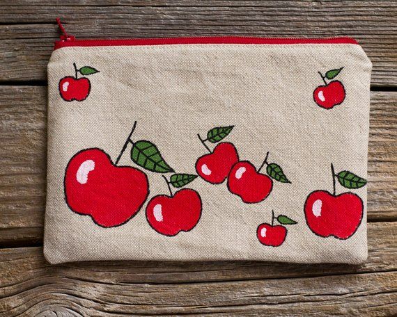 an embroidered pouch with cherries on it