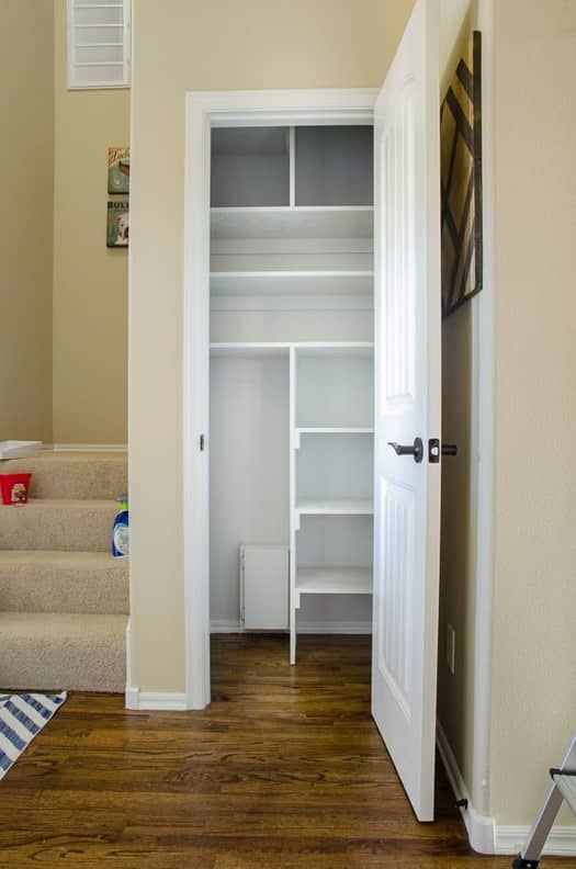 an empty closet with stairs leading up to it