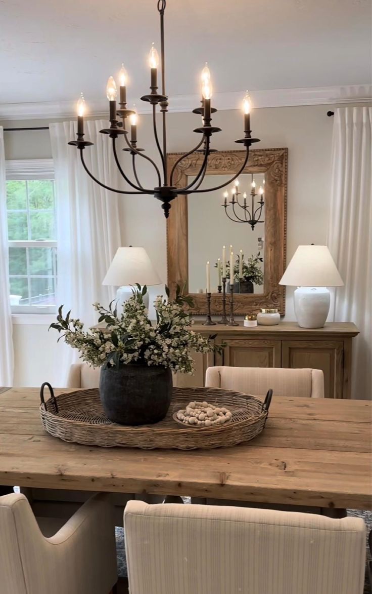 a dining room table with chairs and a chandelier