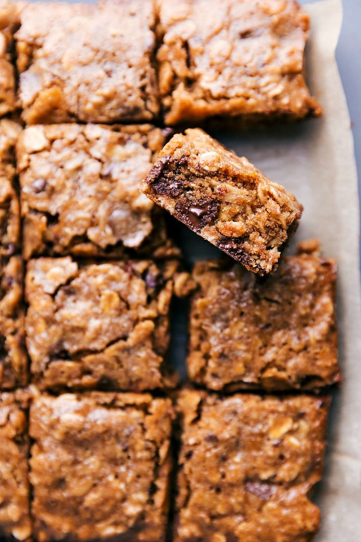 some brownies are stacked on top of each other and one has a bite taken out of it