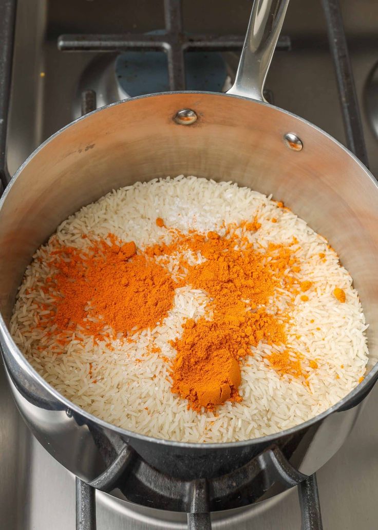 rice and spices cooking in a pot on the stove