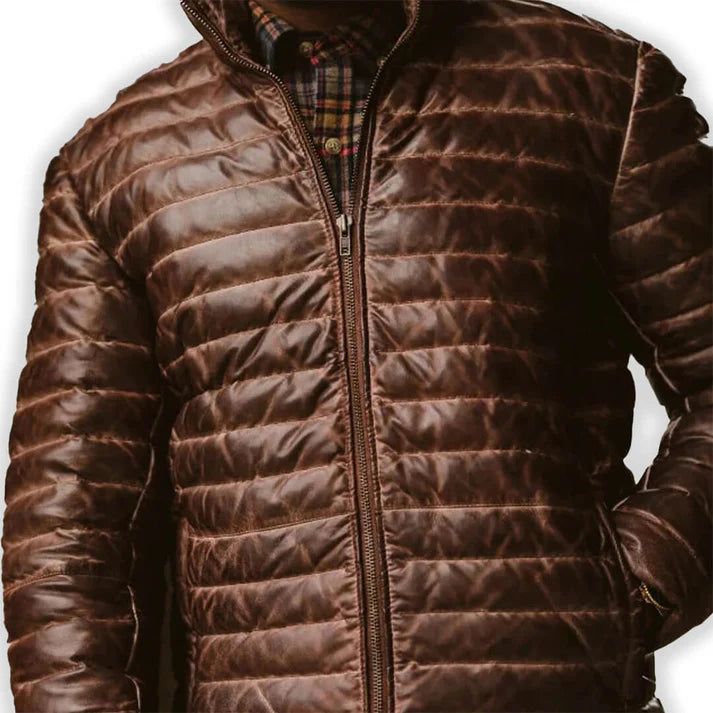 Rugged style meets winter warmth in our Men's Brown Leather Puffer Jacket. Crafted from supple, genuine leather with a rich brown hue, this jacket features quilted puffer insulation for superior heat retention. The classic silhouette is enhanced with a stand-up collar, zippered front, and snug cuffs to keep the cold at bay. Practical side pockets provide storage and hand-warming comfort. Perfect for the fashion-conscious man who doesn't compromise on functionality, this jacket seamlessly transitions from outdoor adventures to city streets. Key features: Premium brown sheepskin leather exterior for durability and style Quilted puffer design for superior insulation Adjustable hem to seal out cold air Multiple pockets for convenient storage Satin lining for a luxurious feel Premium YKK zipper