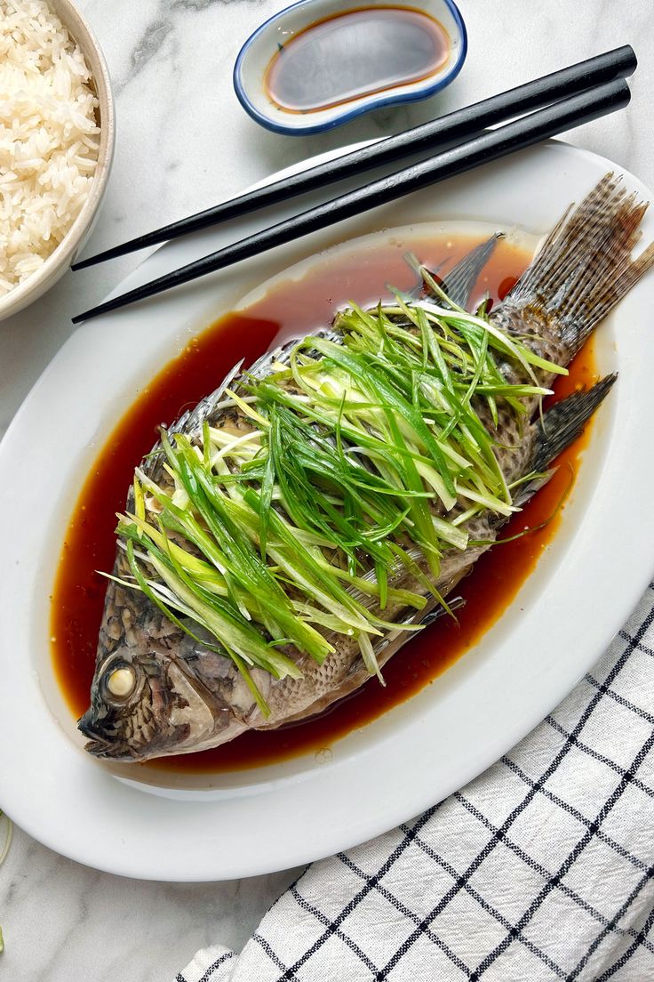 plate of steamed fish with ginger and scallion Chinese Seafood, Traditional Chinese New Year Dishes, Steamed Fish With Ginger And Scallions, Whole Fish, Steam Fish, Chinese Fish, Chinese Dishes Traditional, Authentic Chinese Food, Chinese Food Photography