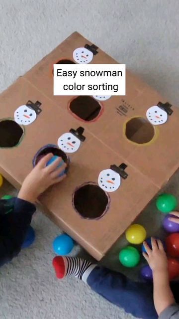 two children playing with an easy snowman color sorting game