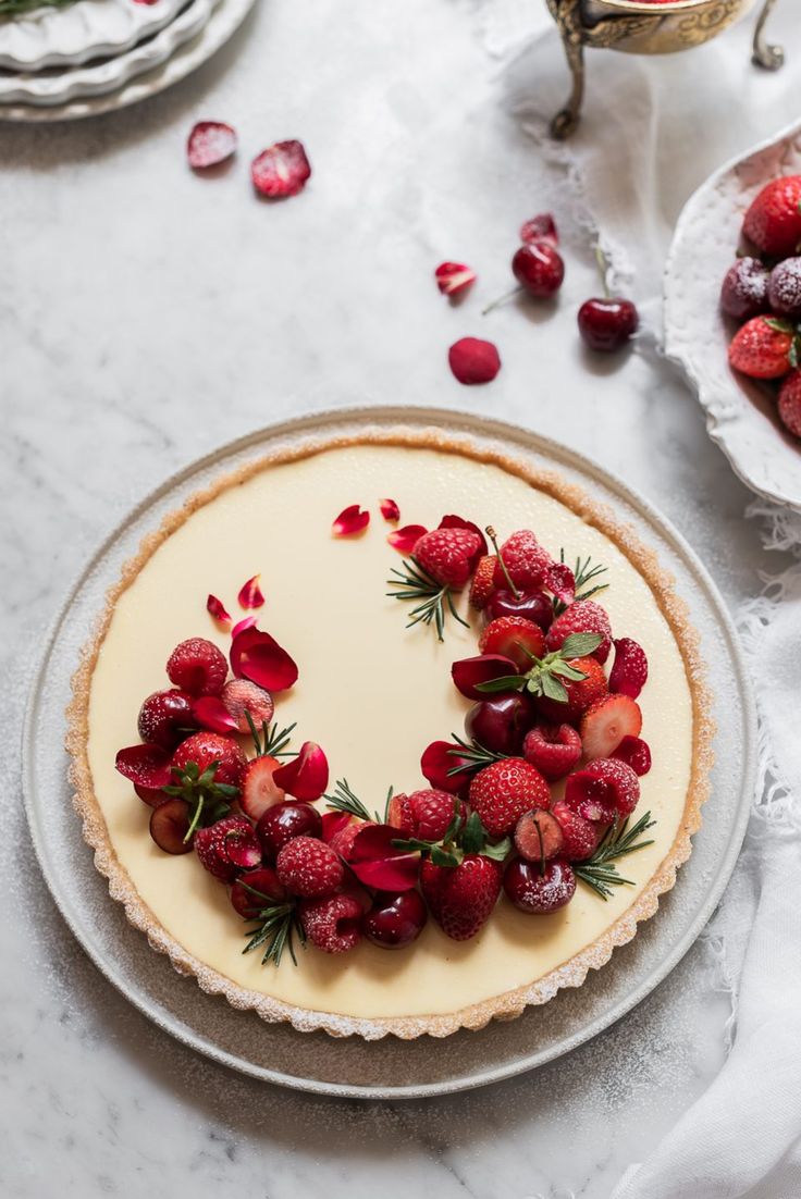 a cheesecake topped with strawberries on top of a table