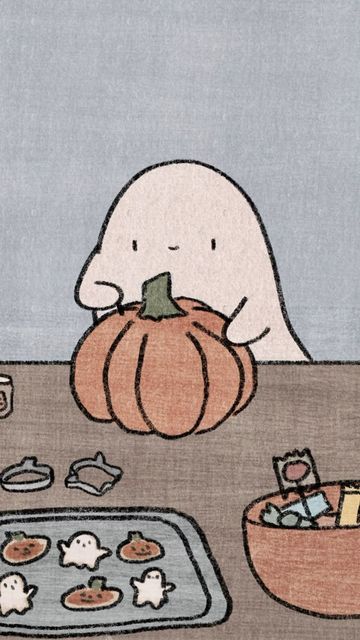 a person sitting at a table in front of a pumpkin and other items on the table