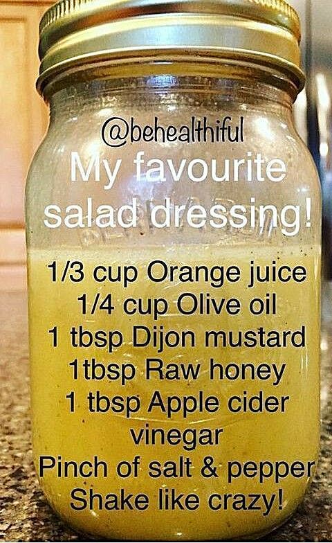 a jar filled with orange juice sitting on top of a counter