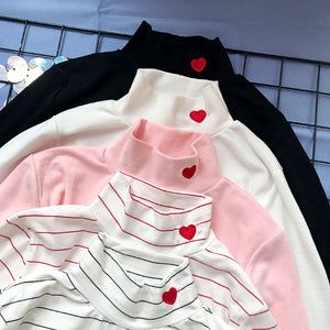 Cute Long Sleeve T-shirt For Spring, Cute Tops With Heart Graphic For Spring, Pink Long Sleeve T-shirt With Heart Graphic, Long Sleeve Heart Print Shirt For Spring, White Long Sleeve Tops With Heart Print, White Long Sleeve Top With Heart Print, Pink Heart Print Stretch Top, Cute White Winter Tops, Cute Black Long Sleeve Tops