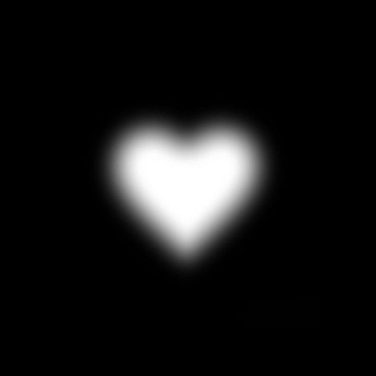 a black and white image of a heart in the dark