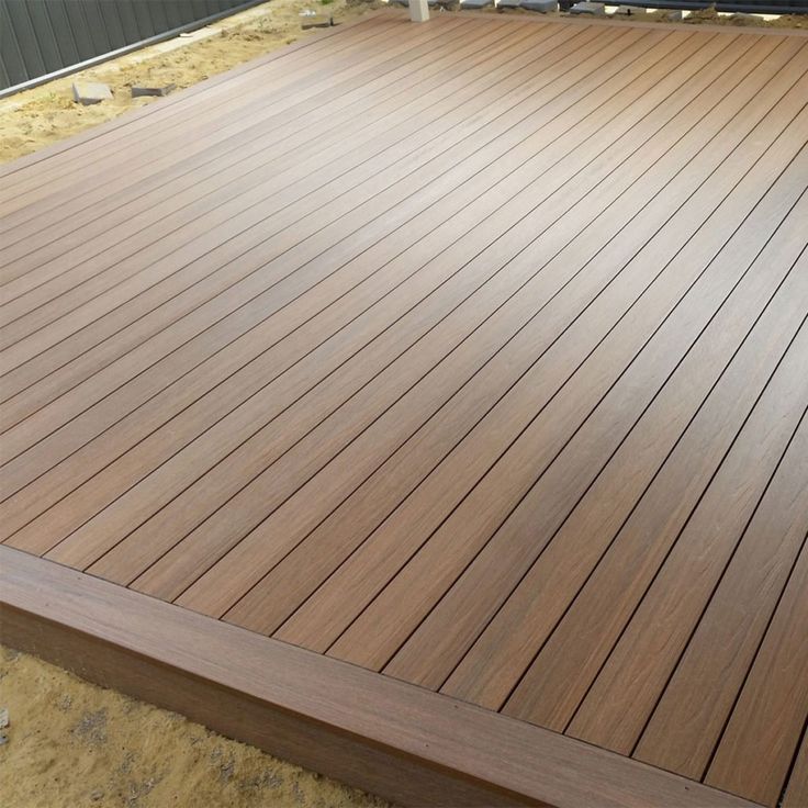 a close up of a wooden deck in the middle of construction work on a house