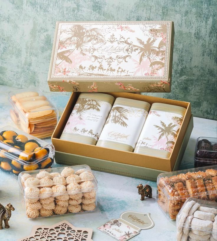 an assortment of cookies and candies in a box on a table with other items