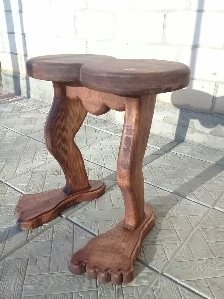 a wooden bench sitting on top of a tiled floor