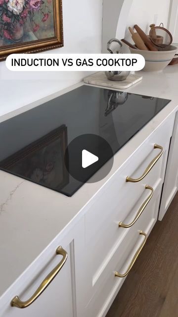 a kitchen counter top with brass handles and an induction gas cooktop