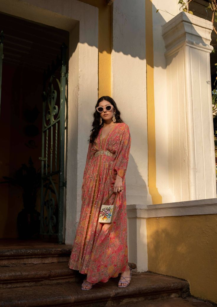 Our easy breezy festive wear kaftan expresses the classic romantic vibe, crafted using multiple prints which is digitally printed on pure georgette. The kaftan is accented with beautiful blooming floral and multi color stripes with dainty printed motifs. It is sprinkled using zari, floral sequins and mirror. It is has attached patch with is heavy embroidered. Festive Floral Print Dresses With Kimono Sleeves, Festive Floral Print Dress With Kimono Sleeves, Floor-length Georgette Kaftan For Spring, Festive Multicolor Floral Print Kaftan, Bohemian Georgette Kaftan With Floral Print, Festive Floral Print Maxi Kaftan, Spring Maxi Length Georgette Kaftan, Spring V-neck Kaftan With Digital Print, Festive Floor-length Floral Print Kaftan