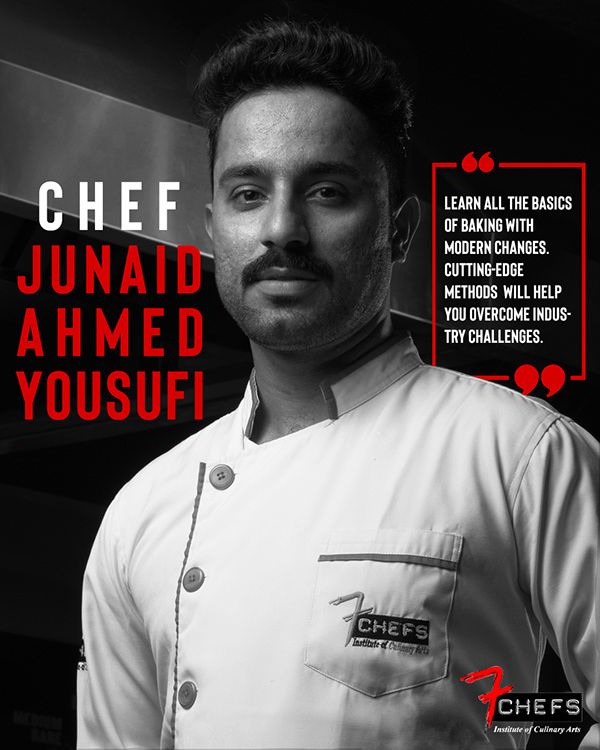 a man with a mustache standing in front of a sign that says chef junaid ahmed yousuf