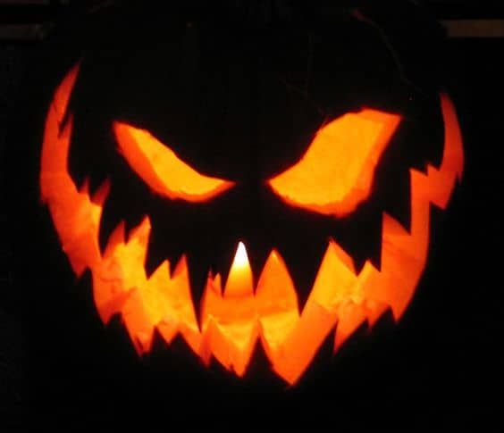 a carved jack o lantern with glowing eyes