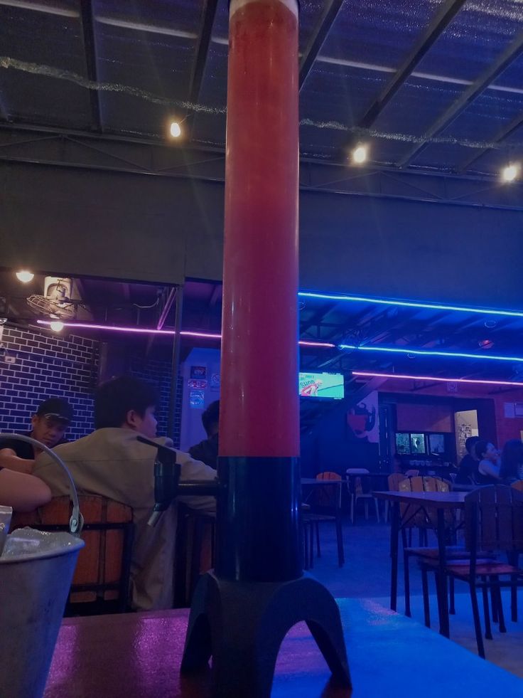 the inside of a restaurant with people sitting at tables