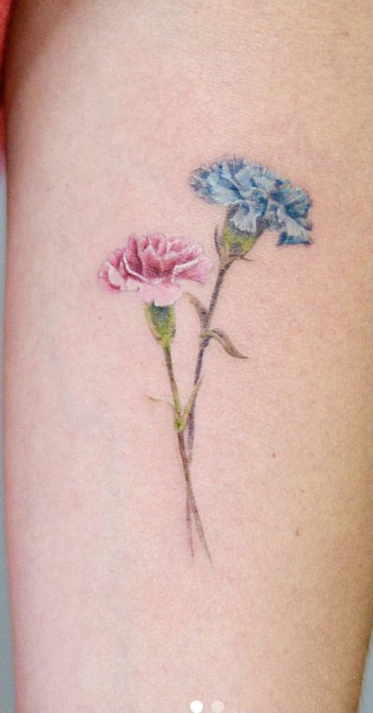 two blue and pink flowers on the back of a woman's stomach