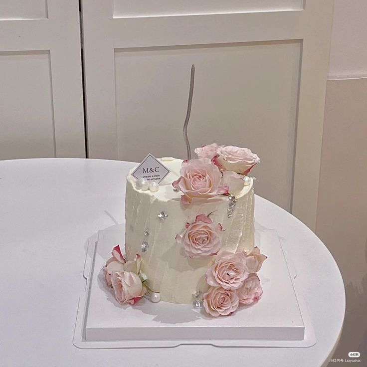 a three tiered cake with pink flowers on top