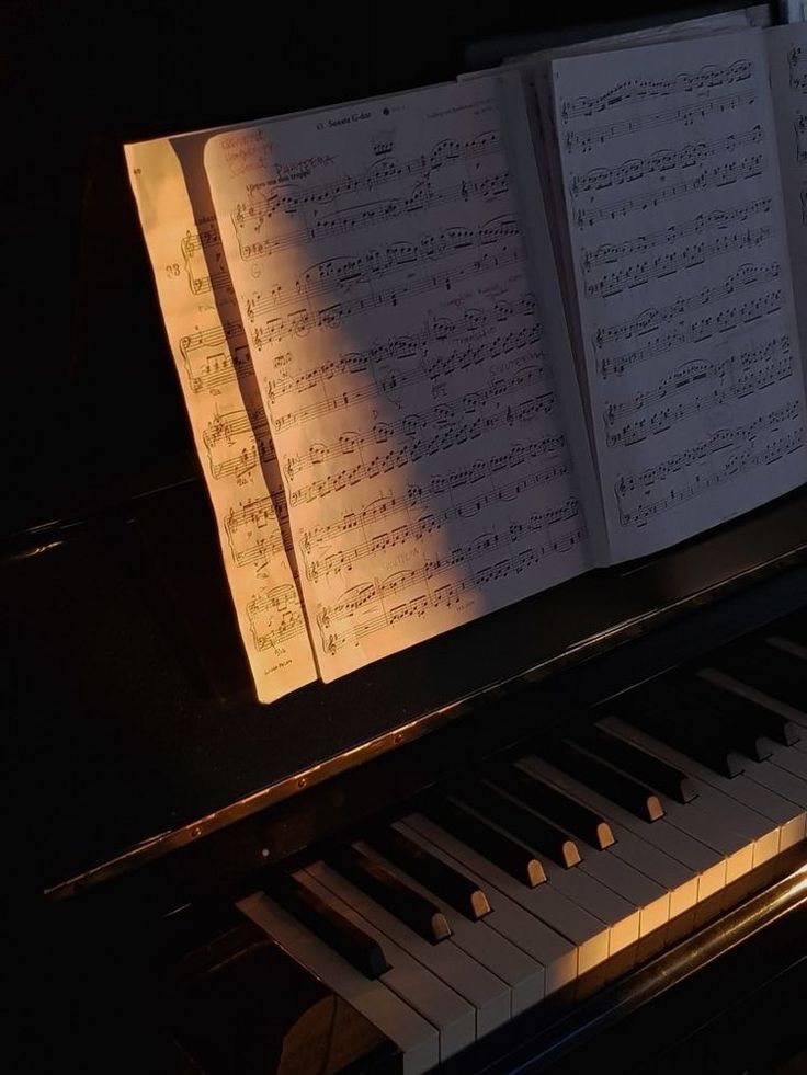 an open book sitting on top of a piano