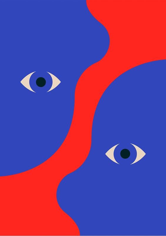 two blue and red cats with their eyes wide open, facing each other in opposite directions