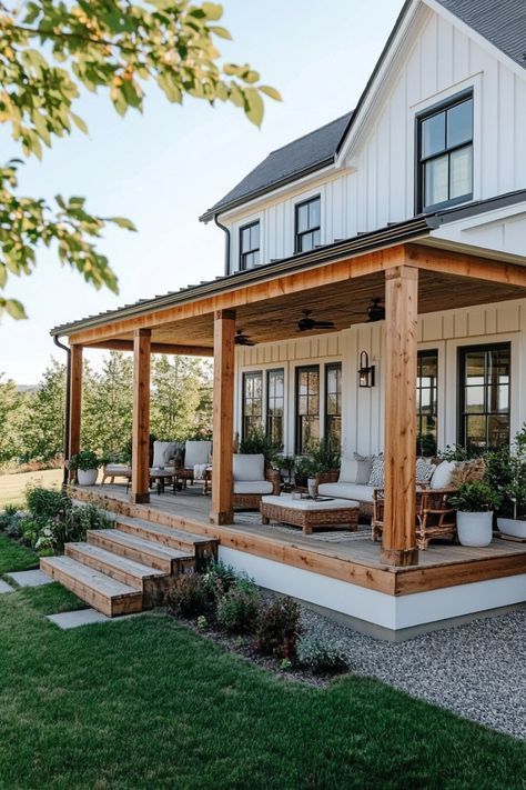 a large white house with porch and covered patio