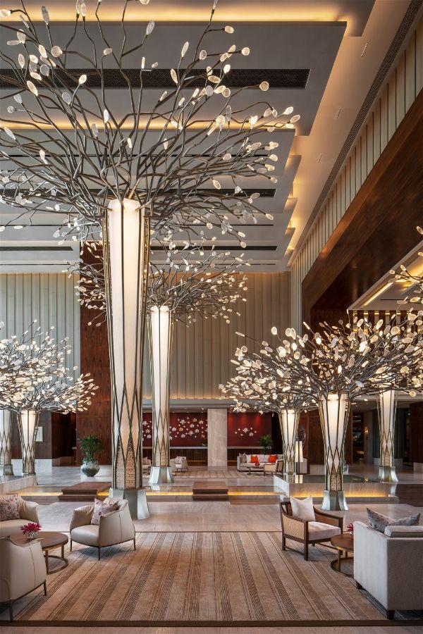 the lobby is decorated with tall, slender trees