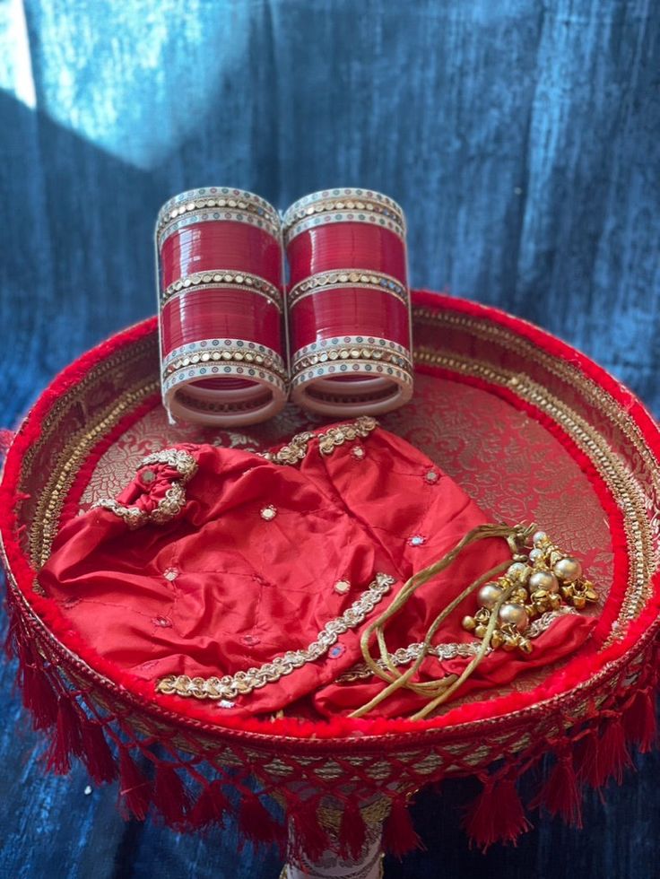 a red tray with two pairs of shoes on top of it next to other items